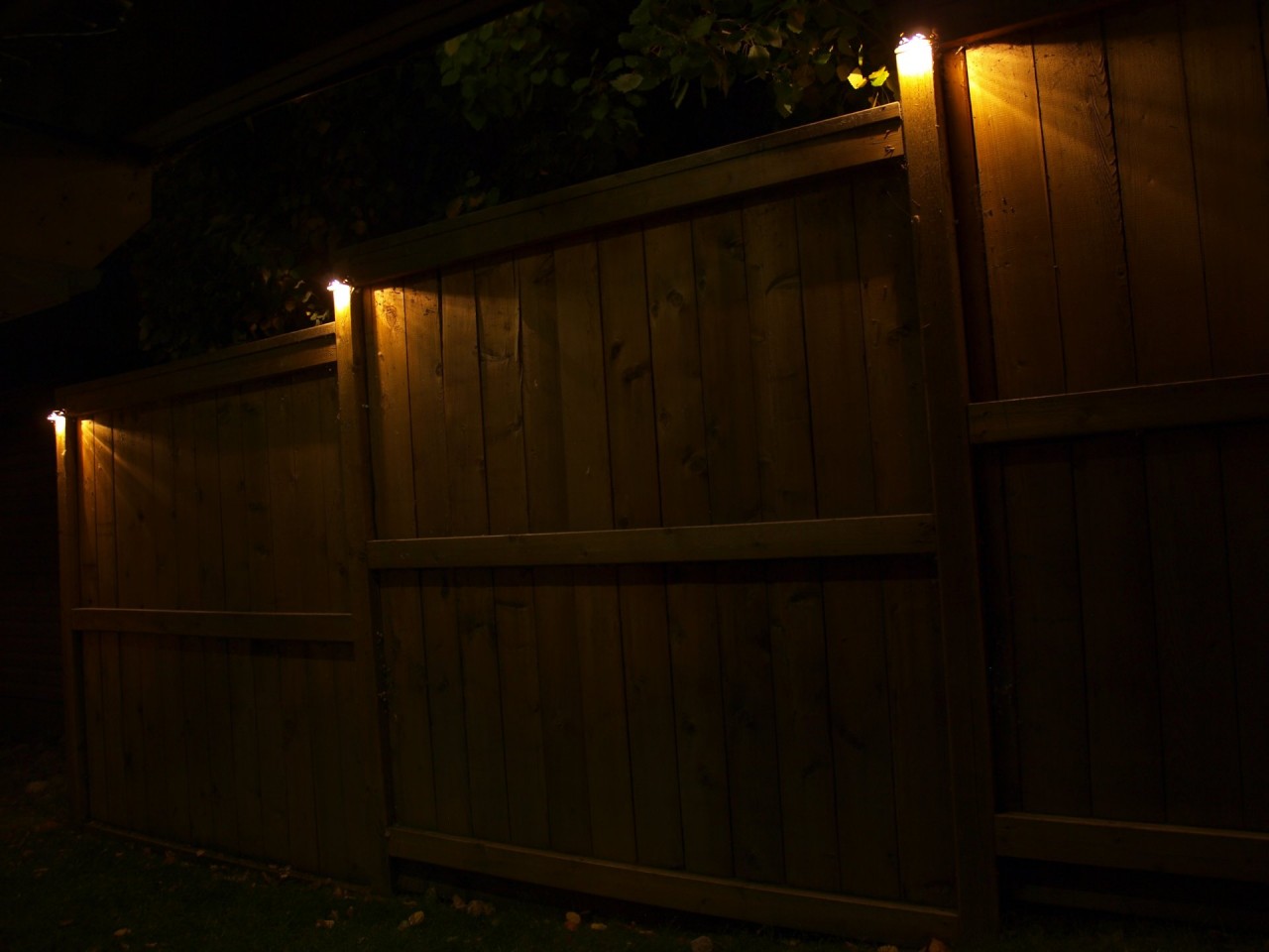 Cup Lights Mounted On Fence Posts Illuminate The Way